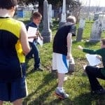 Students examine stones in the Big Run Cemetery.