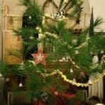 This live tabletop tree was decorated with vintage items, antique blown-glass ornaments, and handmade popcorn chains.