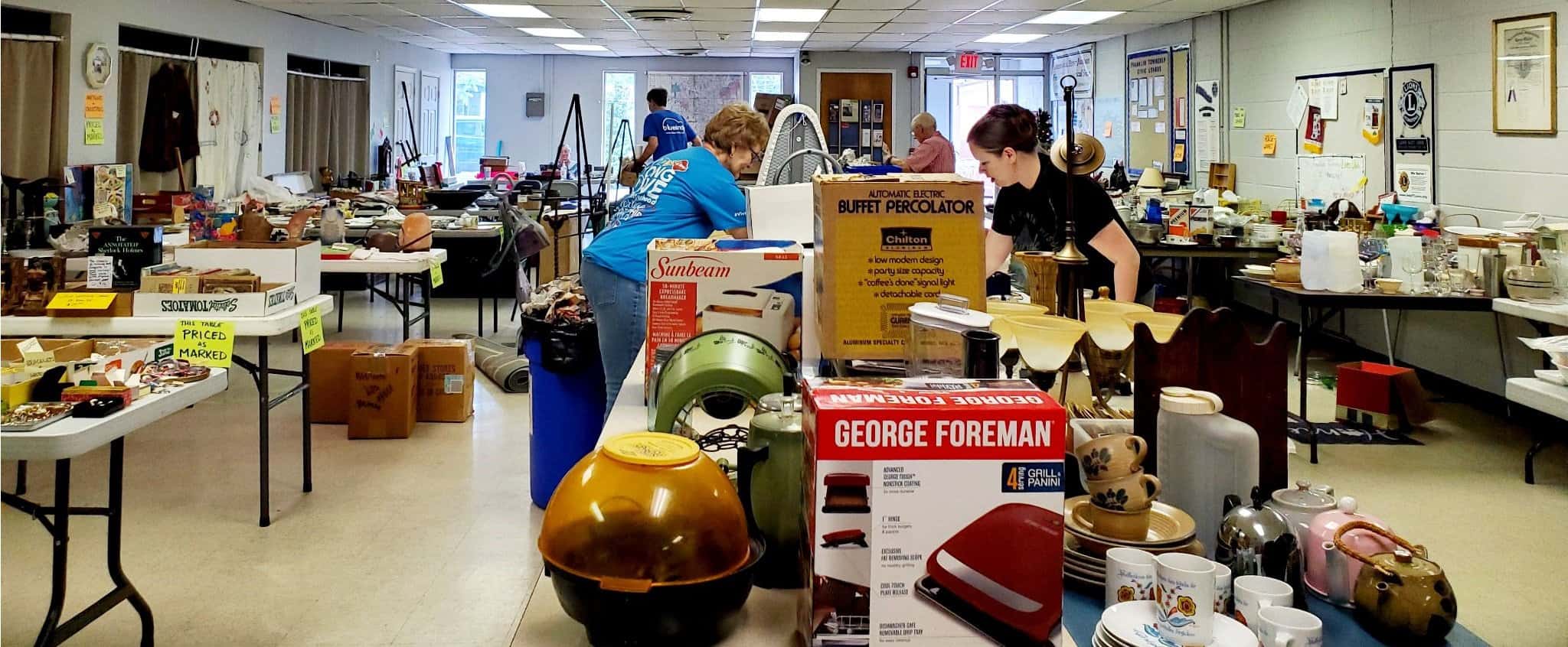 volunteers setting up 2022 rummage sale