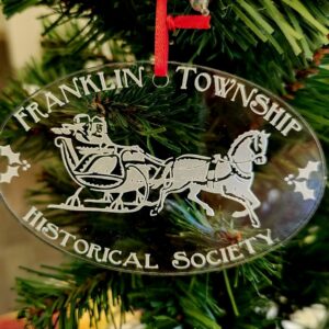 Christmas ornament featuring a horse-drawn sleigh